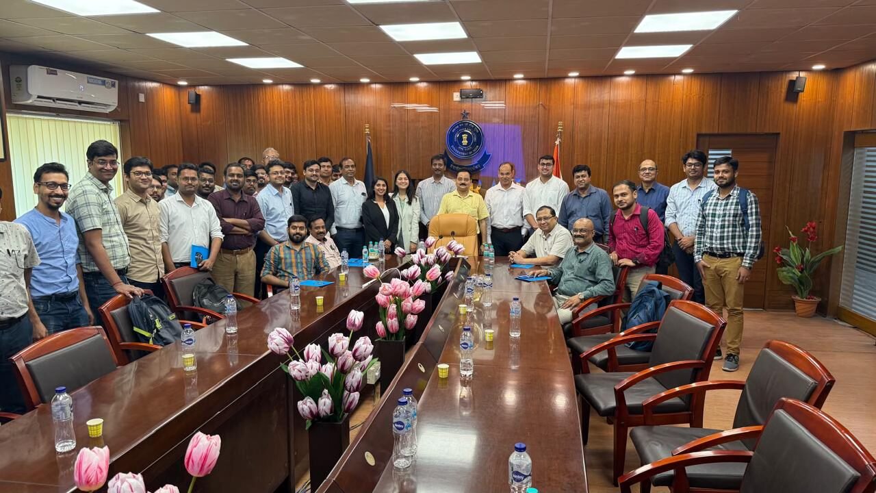 Officers and participants gathered around a long conference table in a Customs office meeting room